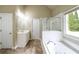 Bathroom boasts a soaking tub, separate glass shower and ample natural light at 570 Highcrest Dr, Acworth, GA 30101