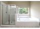 This bathroom features a separate shower, soaking tub and window at 570 Highcrest Dr, Acworth, GA 30101