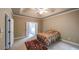 Bedroom features a tray ceiling, ceiling fan and neutral decor with a rug at 570 Highcrest Dr, Acworth, GA 30101