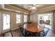 Dining area features a wood table with black chairs, a ceiling fan and exterior door at 570 Highcrest Dr, Acworth, GA 30101