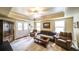 Cozy carpeted living room featuring comfortable seating, a ceiling fan, and a large window at 570 Highcrest Dr, Acworth, GA 30101