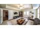 Carpeted living room featuring a comfortable seating area, a large TV, and doors to the exterior at 570 Highcrest Dr, Acworth, GA 30101