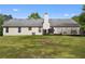 Large backyard with a well-maintained lawn, a patio, a grill and mature trees at 129 Lakepointe Ct, Stockbridge, GA 30281