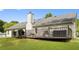 Spacious backyard with a well-maintained lawn, mature trees and a charcoal grill at 129 Lakepointe Ct, Stockbridge, GA 30281