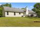 Spacious backyard with a well-maintained lawn, mature trees, and a charming deck at 129 Lakepointe Ct, Stockbridge, GA 30281