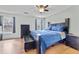 Spacious bedroom with a ceiling fan, two large windows, and hardwood floors at 129 Lakepointe Ct, Stockbridge, GA 30281