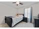 Calming bedroom with carpet floors, a ceiling fan, two large windows, and stylish decor at 129 Lakepointe Ct, Stockbridge, GA 30281