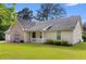 Beautiful single-story home with a well-maintained lawn, neutral siding, and brick facade at 129 Lakepointe Ct, Stockbridge, GA 30281