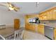 Eat-in kitchen featuring wooden cabinets, stainless steel appliances, and tile floors at 129 Lakepointe Ct, Stockbridge, GA 30281