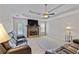 Comfortable living room with a stone fireplace, ceiling fan, and neutral paint at 129 Lakepointe Ct, Stockbridge, GA 30281