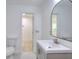Modern bathroom featuring a gray vanity, mirror, toilet and open door to the stand-up shower at 2094 Shamrock Dr, Decatur, GA 30032