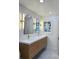 Bathroom with double vanity, gold fixtures, framed mirrors, and modern lighting at 2094 Shamrock Dr, Decatur, GA 30032