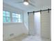 Bedroom with vinyl floors, natural light from a window and a white barn door at 2094 Shamrock Dr, Decatur, GA 30032
