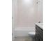 Clean bathroom with a standard bathtub, dark vanity, and tiled walls at 308 Chardonnay Way, Woodstock, GA 30188