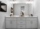 Bright bathroom featuring double sink vanity and quartz countertop, with modern fixtures and ample storage at 308 Chardonnay Way, Woodstock, GA 30188