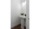 Elegant half-bathroom with pedestal sink, modern lighting, and minimalist design at 308 Chardonnay Way, Woodstock, GA 30188