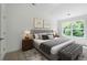 Well-lit bedroom featuring a comfy bed, decor, and a large window with backyard view at 308 Chardonnay Way, Woodstock, GA 30188