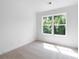 Bedroom with neutral carpet and a large window offering natural light and backyard view at 308 Chardonnay Way, Woodstock, GA 30188