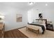 Well-lit bedroom with light-colored walls, wood floors, and comfortable furnishings at 308 Chardonnay Way, Woodstock, GA 30188