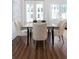 Well-lit dining room with a table, four chairs, and wood flooring at 308 Chardonnay Way, Woodstock, GA 30188