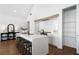 Modern kitchen features a large island with seating and sleek, white cabinetry at 308 Chardonnay Way, Woodstock, GA 30188