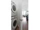 Conveniently located laundry room with stacked washer and dryer, leading to living area at 308 Chardonnay Way, Woodstock, GA 30188