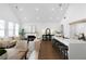 Open-concept living room and kitchen featuring hardwood floors, fireplace and natural light at 308 Chardonnay Way, Woodstock, GA 30188