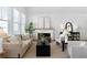 Bright and airy living room with neutral decor, fireplace, and large windows at 308 Chardonnay Way, Woodstock, GA 30188