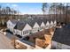 Aerial view of new white townhomes with a dark roof and manicured landscaping at 308 Chardonnay Way, Woodstock, GA 30188