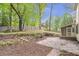 Spacious backyard with mature trees, stone patio and access to the screened porch at 3761 Bays Ferry Way, Marietta, GA 30062