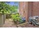 An image of a backyard with brick wall, greenery, and a wooden fence for privacy at 3761 Bays Ferry Way, Marietta, GA 30062