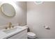 Updated half bathroom includes modern fixtures and round mirror at 3761 Bays Ferry Way, Marietta, GA 30062
