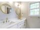 Bathroom with dual sinks, white cabinets and countertops, plus brushed gold fixtures at 3761 Bays Ferry Way, Marietta, GA 30062