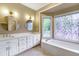 A dual sink vanity with stylish fixtures sits next to a large soaking tub at 3761 Bays Ferry Way, Marietta, GA 30062