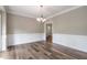 Formal dining room boasts wainscoting detail, wood-look floors, and elegant lighting at 3761 Bays Ferry Way, Marietta, GA 30062