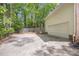 A large concrete driveway and two-car garage exterior, surrounded by mature trees at 3761 Bays Ferry Way, Marietta, GA 30062