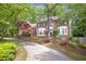 Traditional two-story brick home featuring bay windows and a well-manicured lawn at 3761 Bays Ferry Way, Marietta, GA 30062