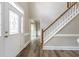 Bright foyer featuring wood-look floors, staircase, and leaded glass front door at 3761 Bays Ferry Way, Marietta, GA 30062