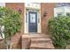 Inviting front entrance features a leaded glass door with sidelights, sconces, and brick steps at 3761 Bays Ferry Way, Marietta, GA 30062