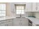 Well-lit kitchen showcasing white cabinets, quartz countertops, and stainless steel appliances at 3761 Bays Ferry Way, Marietta, GA 30062