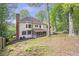 Spacious lot showcasing rear elevation with screened porch and stone patio at 3761 Bays Ferry Way, Marietta, GA 30062