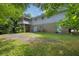 Expansive backyard featuring lush greenery, patio area, and house exterior with a screened in porch at 3929 Emerald Springs Ct, Decatur, GA 30035