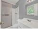 A bathroom with a shower with sliding doors, a vanity with a sink, and a window at 3929 Emerald Springs Ct, Decatur, GA 30035