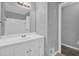Bathroom featuring a single sink vanity, a mirror, and a walk-in shower at 3929 Emerald Springs Ct, Decatur, GA 30035