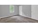 A bright bedroom with plush carpeting, natural light, and freshly painted white doors at 3929 Emerald Springs Ct, Decatur, GA 30035