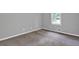 A well-lit bedroom with plush carpeting and a window offering natural light at 3929 Emerald Springs Ct, Decatur, GA 30035