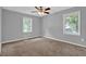 Bedroom with neutral walls, carpeting, two windows, and a ceiling fan at 3929 Emerald Springs Ct, Decatur, GA 30035