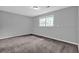 Bedroom featuring neutral walls, carpeting, a window, and a ceiling light at 3929 Emerald Springs Ct, Decatur, GA 30035