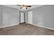 Bedroom featuring neutral walls, carpeting, two doors, and a ceiling fan at 3929 Emerald Springs Ct, Decatur, GA 30035