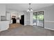 Open-concept dining area with a view of the kitchen and sliding doors to the screened deck at 3929 Emerald Springs Ct, Decatur, GA 30035
